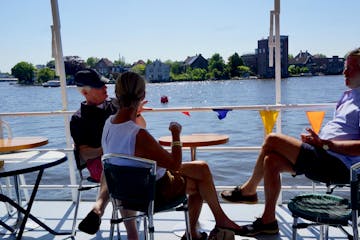 Three people sitting at a table on the boat