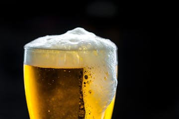 Glass of beer with a little foam on top