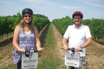 Couple on segways in vineyard