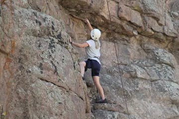 A rock climber finding grips