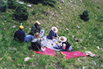 a group of people sitting in a field
