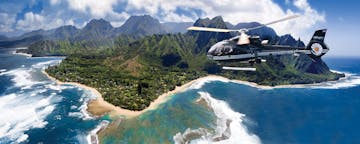 a helicopter flying alongside the coast of Kauai
