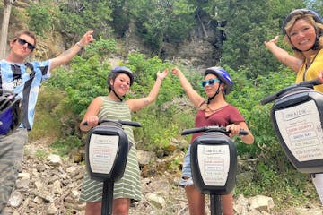 a few people on Segways in front of the Niagara Escarpment