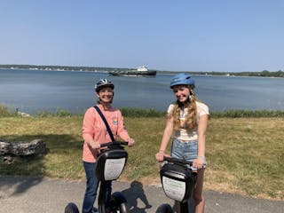 Mother and daughter posing on Segways