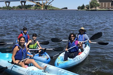A family in their kayaks on Lake Michigan