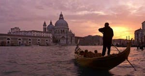 Gondolier pushing a gondola in Venice
