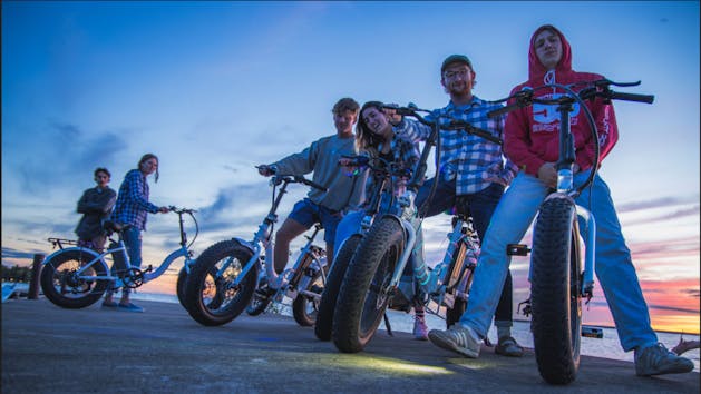 a group of people riding on the back of a motorcycle