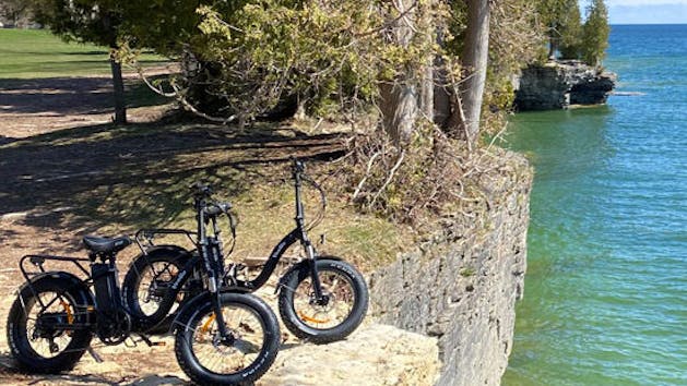 a bicycle is parked next to a body of water