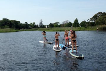 group of moms on stand up paddleboards