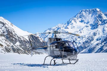 Helicopter landing on Tasman Glacier with Mountain cook in the background