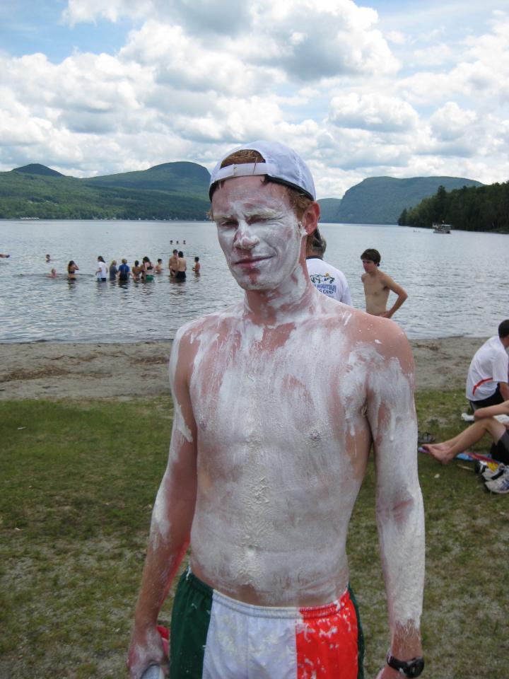 a man standing next to a body of water