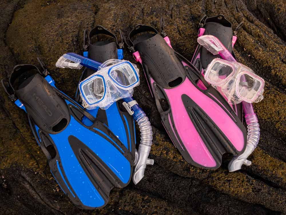 2 sets of snorkel gear sitting on lava rock