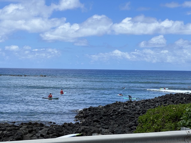 a group of people on a beach near a body of water