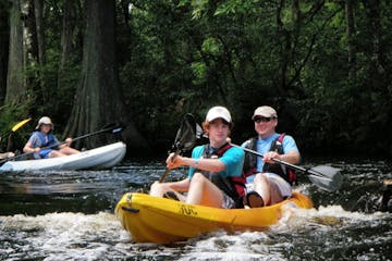 Kayakers paddling through Riverbend Park