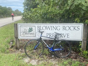 a bicycle parked in front of a sign