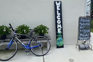 a bicycle parked in front of a blue wall