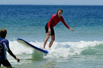 a girl riding a wave on a surfboard in the ocean