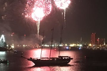 fireworks in the sky over a body of water