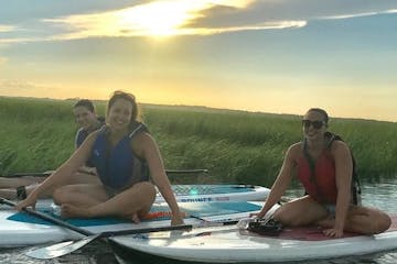 three girls on paddle boards