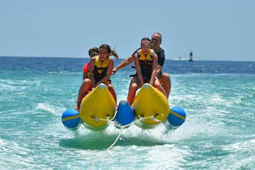Banana boat riders flying through water