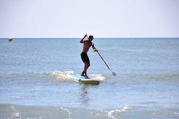 Stand up paddle boarder in the ocean in myrtle beach