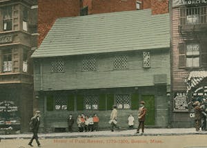 a group of people walking in front of Paul Revere House