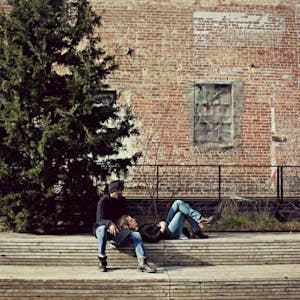 two people sitting on a bench on the high line