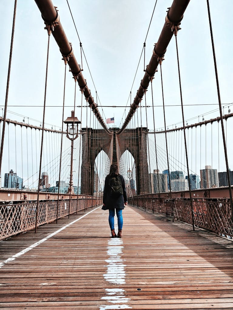 a person walking on the brooklyn bridge