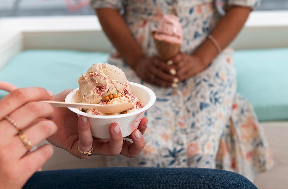 a woman holding a bowl of ice cream