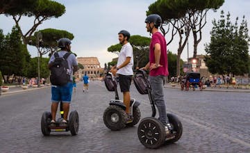 boys riding segways in front of the Colosseum