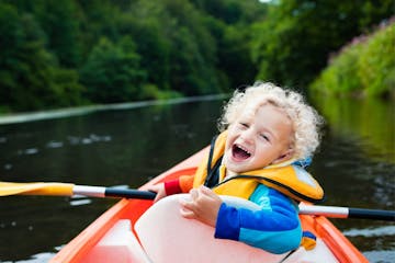 smiling boy in a kayak