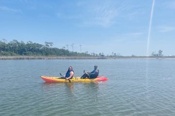 a couple kayaking on a body of water in Alabama