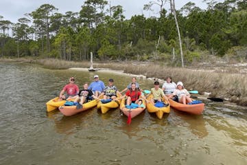 a group of people on a kayak in a body of water