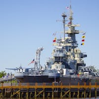Battleship North Carolina with walkway during the day