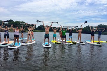 Group of people on a stand up paddle board event