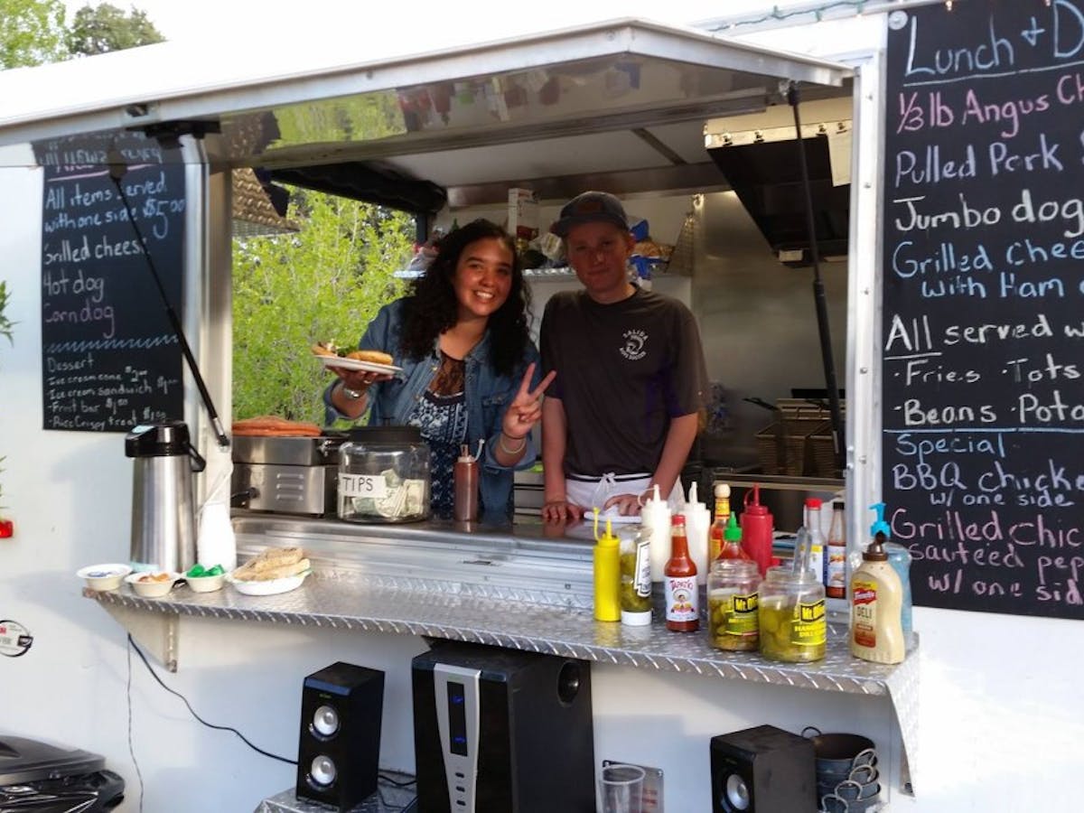 food truck with people smiling