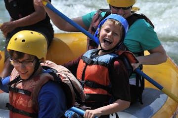 child smiling and rafting