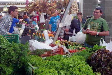 people buying food at market