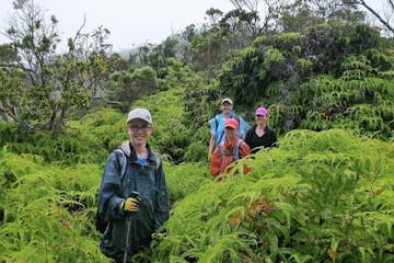 Family hiking group posing for a picture in the jungle brush