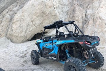 a RZR parked in front of a bat cave near Palm Springs, California