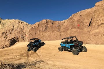 two blue UTV's drive in the sand in the Californian desert