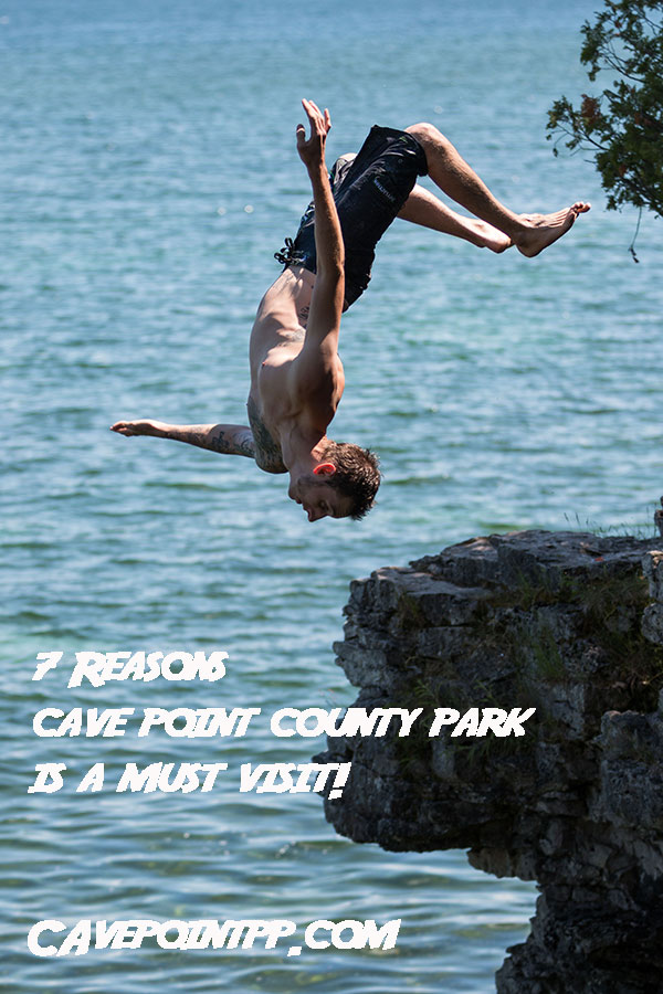 a guy doing a backflip cliff jump at cave point