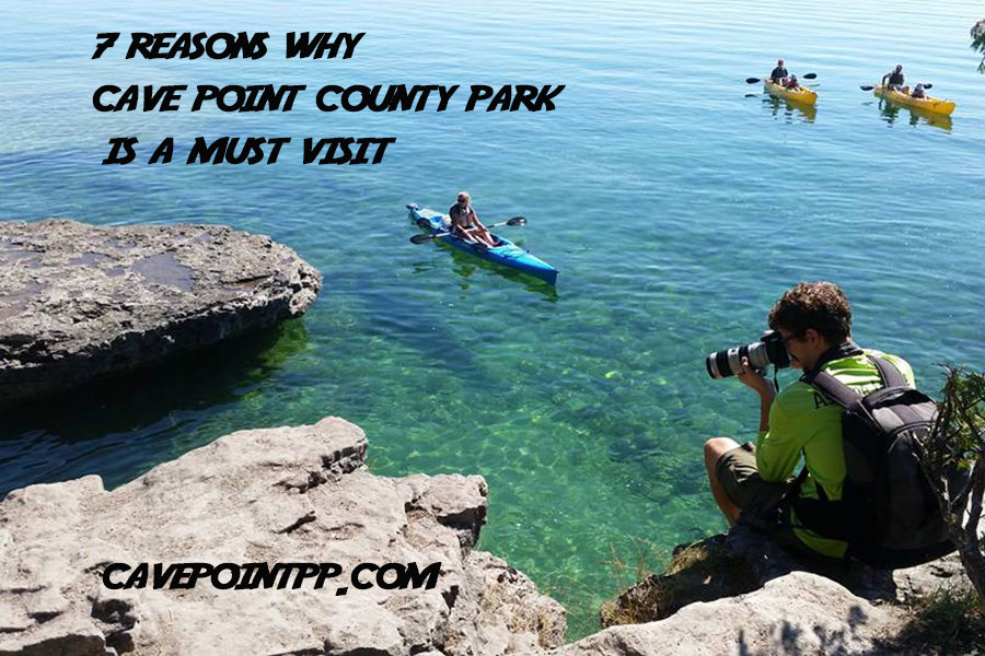 a photographer at cave point county park taking a photo of a kayak tour