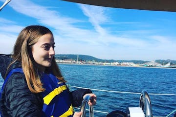 A girl driving a boat