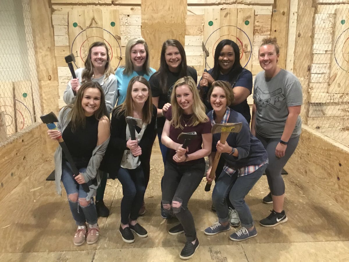 group posing with axes at Civil Axe Throwing