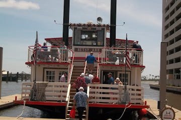 riverboat at the dock with people boarding