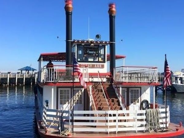 betsy ann riverboat on water with american flags