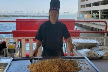 Hibachi chef making food on dinner cruise smiling