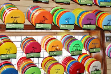 A rack of disk golf disks