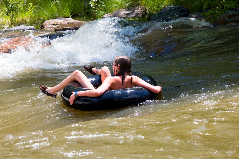 A woman tubes down clearcreek water park in golden colorado